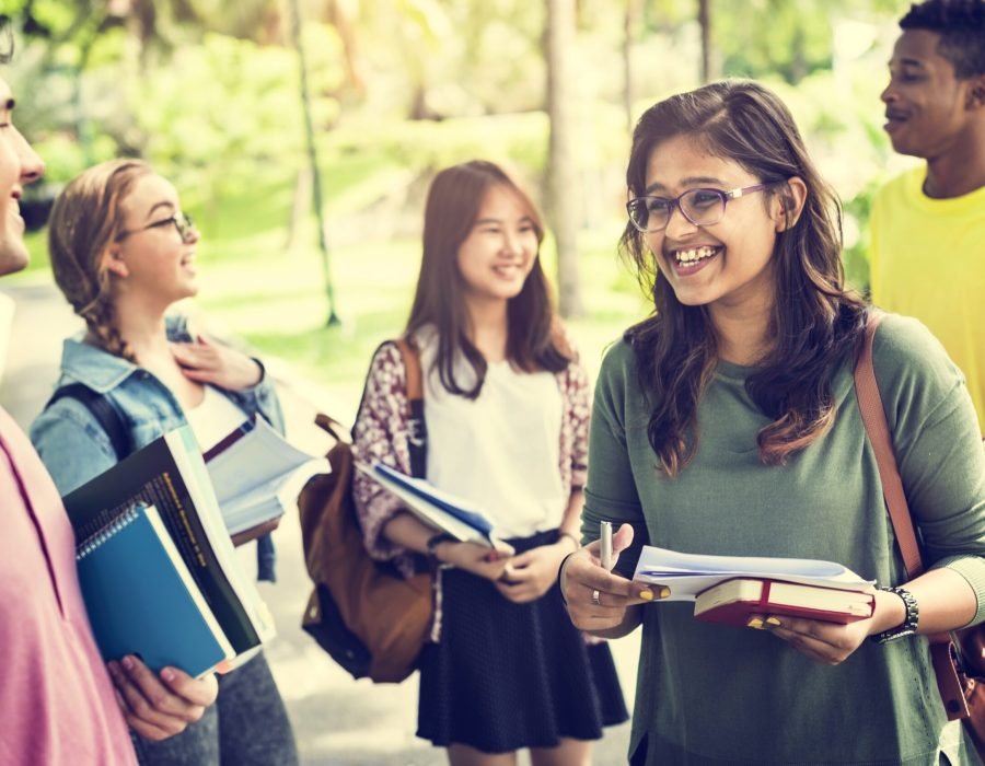 Diverse Young Students Book Outdoors Concept